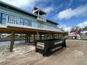 A Super Duper Dumpsters roll-off container delivered to a beach house construction site in Mobile, AL.