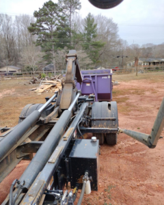 An All In Waste dumpster being delivered to a construction or cleanout site in Greenville, SC.