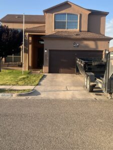 A dump trailer being delivered to a residential property for junk removal by Construction Removal Services Inc. in El Paso, TX.