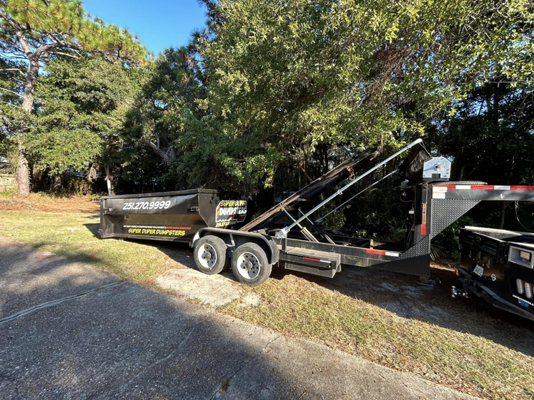 The hydraulic lifting system of a Super Duper Dumpsters roll-off trailer in Mobile, AL, ready for operation.