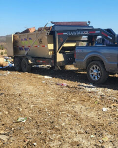 A dumpster filled with various junk and debris from a completed junk removal job by Curry Dumpster Rentals LLC in Southaven, MS.