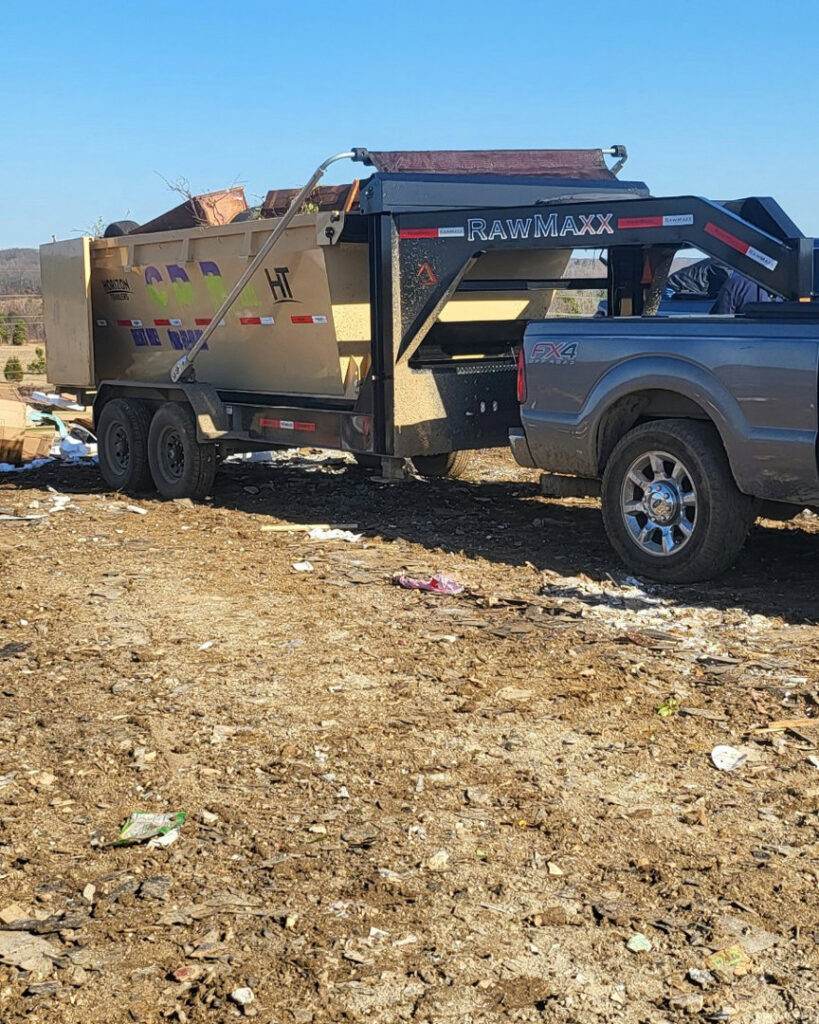 A dumpster filled with various junk and debris from a completed junk removal job by Curry Dumpster Rentals LLC in Southaven, MS.