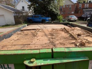 A Frog Hauling dumpster filled with wood debris from a general junk removal job in Columbus, OH.