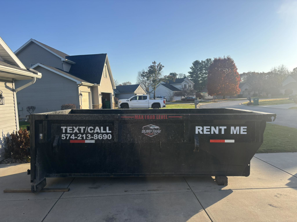 A Dump that Junk LLC dumpster placed in a residential driveway on a sunny day in Mishawaka, IN.