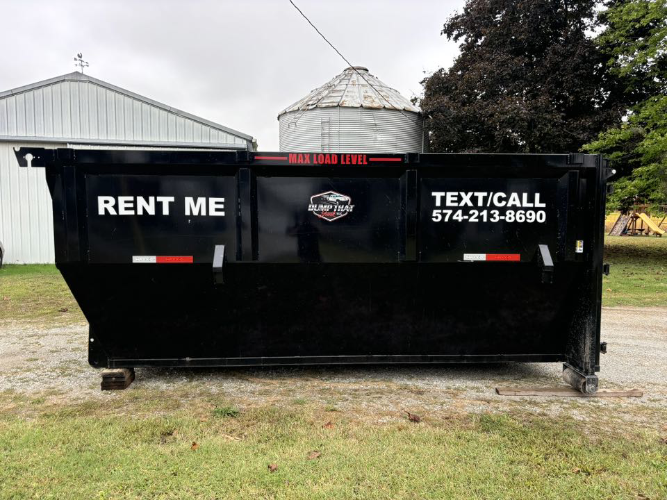 A Dump that Junk LLC dumpster placed in a rural setting with a silo in the background in Mishawaka, IN.