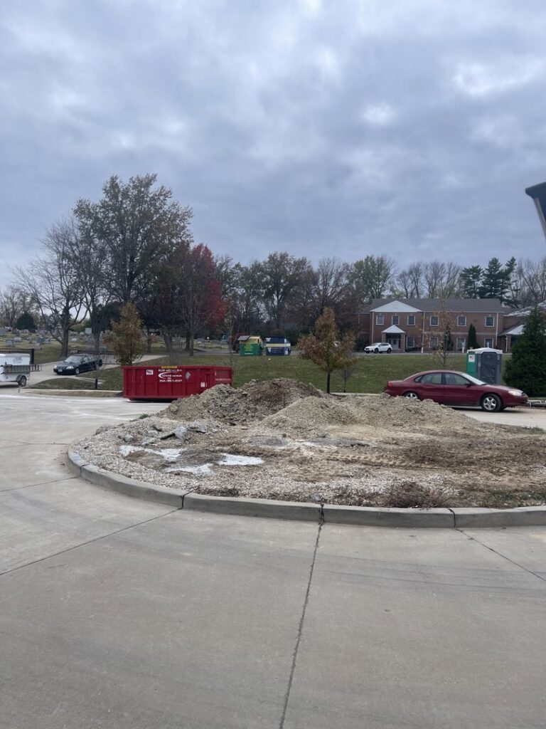 A Beck Disposal Inc. roll-off dumpster placed next to a pile of debris in St. Louis, MO