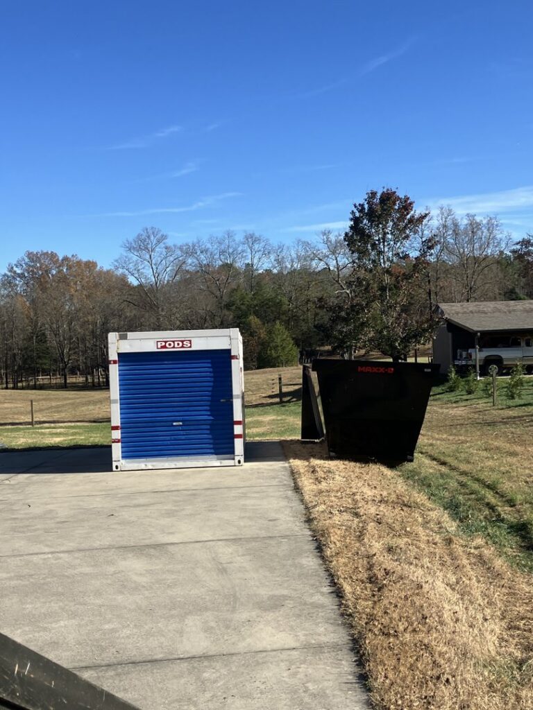 A dumpster from Mobile Dumpster Solutions placed next to a storage container for a residential cleanout in Chattanooga, TN.