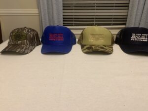 A Bluff City Dumpsters roll-off dumpster placed on a paved area with trees in the background in Memphis, TN.