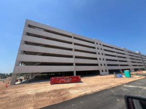A redbox+ dumpster at a parking garage construction site for redbox+ Dumpsters of Greater Austin in Austin, TX