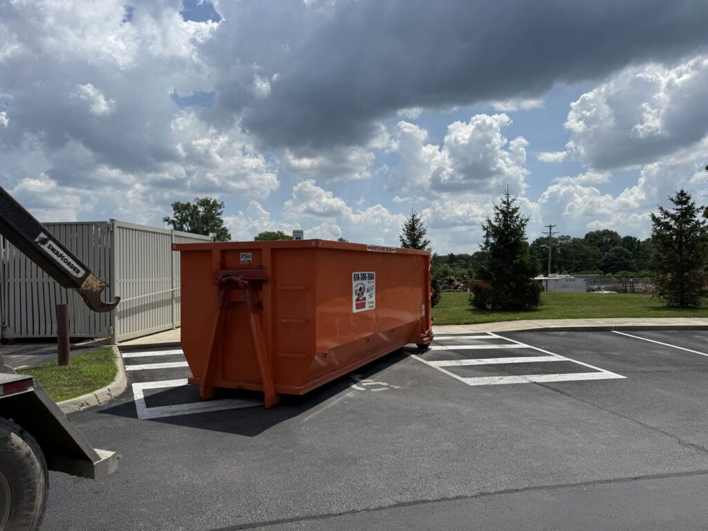 A truck performing a dumpster placement or pickup service for junk removal by Lil Man W/A Can LLC in Columbus, OH.