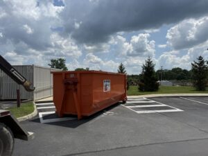 A truck performing a dumpster placement or pickup service for junk removal by Lil Man W/A Can LLC in Columbus, OH.