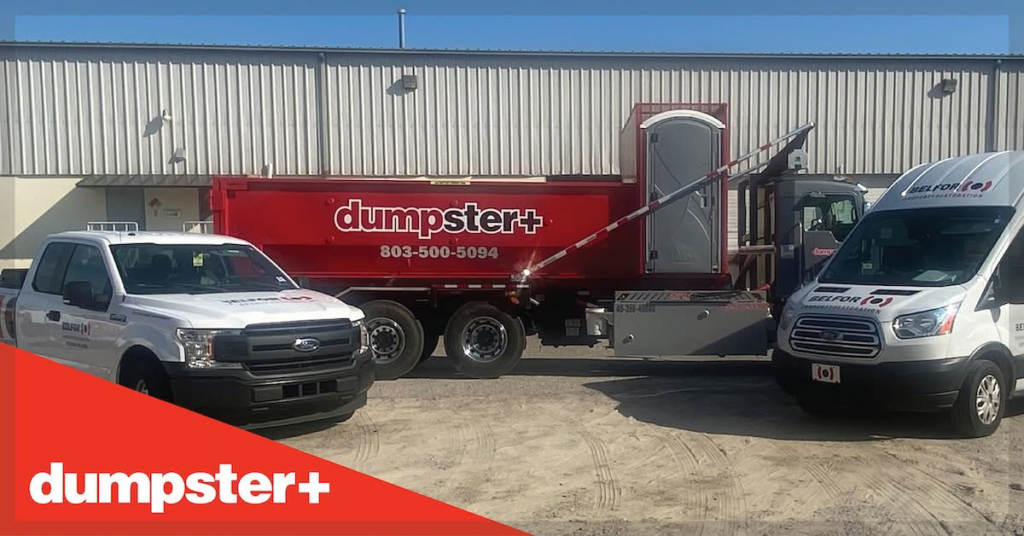 A red dumpster+ roll-off dumpster with a portable toilet, truck, and van for junk removal in Columbia, SC.