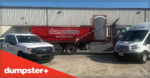 A red dumpster+ roll-off dumpster with a portable toilet, truck, and van for junk removal in Columbia, SC.