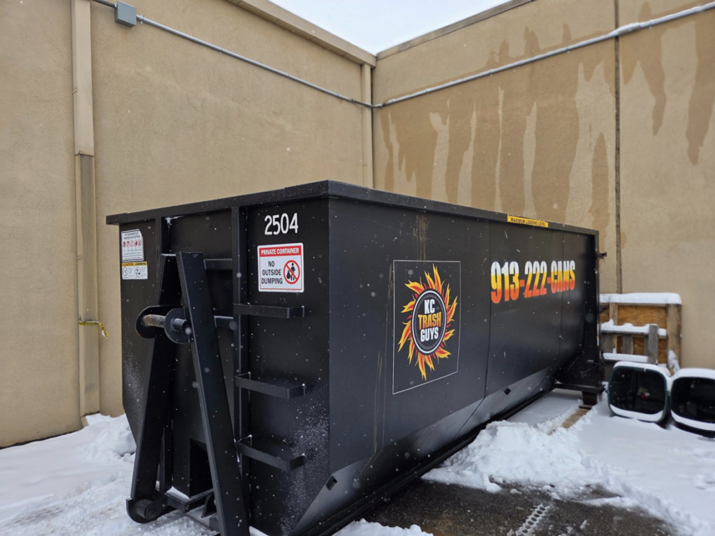 A black dumpster from KC TRASH GUYS LLC ready for junk removal service in Johnson county, MO.