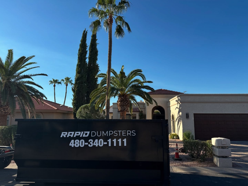 A Rapid Dumpsters container positioned at a residential property for junk removal in Chandler, AZ.