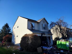 A Frog Hauling dumpster at a house undergoing roofing work for debris removal in Columbus, OH.