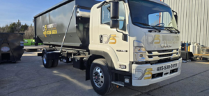 A clean Dumpster Solutions LLC truck with a roll-off dumpster ready for junk removal services in Oklahoma City, OK.