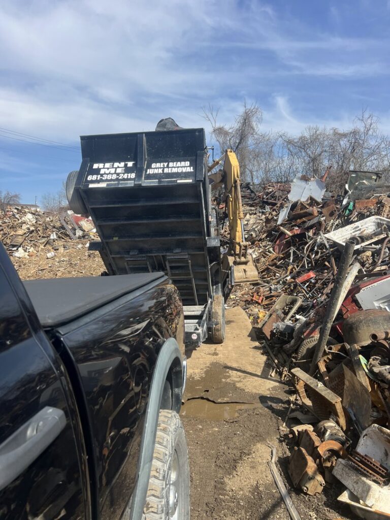 A Greybeard Dumpster Rentals trailer at a scrap yard, ready to unload junk in Morgantown, WV.
