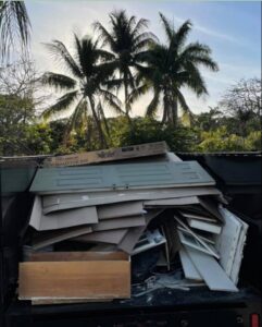 A Driveway Safe Dumpster Rental trailer filled with construction debris from a junk removal project in Fort Lauderdale, FL.