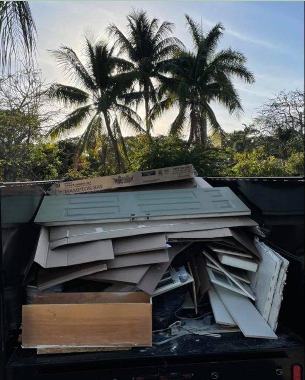 A Driveway Safe Dumpster Rental trailer filled with construction debris from a junk removal project in Fort Lauderdale, FL.