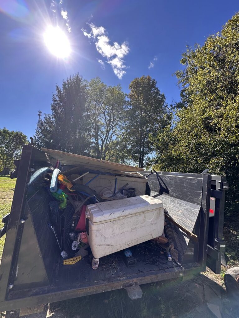 A dumpster trailer filled with household junk and debris, ready for removal by Top Tier Waste Services LLC in Lancaster, OH