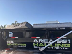 A dump trailer from Area 661 Hauling loaded with two mattresses for removal in Bakersfield, CA.