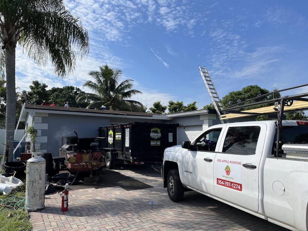 A Driveway Safe Dumpster Rental trailer on site for a roofing project, collecting debris in Fort Lauderdale, FL.