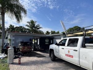 A Driveway Safe Dumpster Rental trailer on site for a roofing project, collecting debris in Fort Lauderdale, FL.