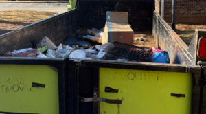 A dumpster or truck bed containing various junk items like cardboard boxes and metal, collected by 247 Junk Removal Greenville SC in Greenville, SC.