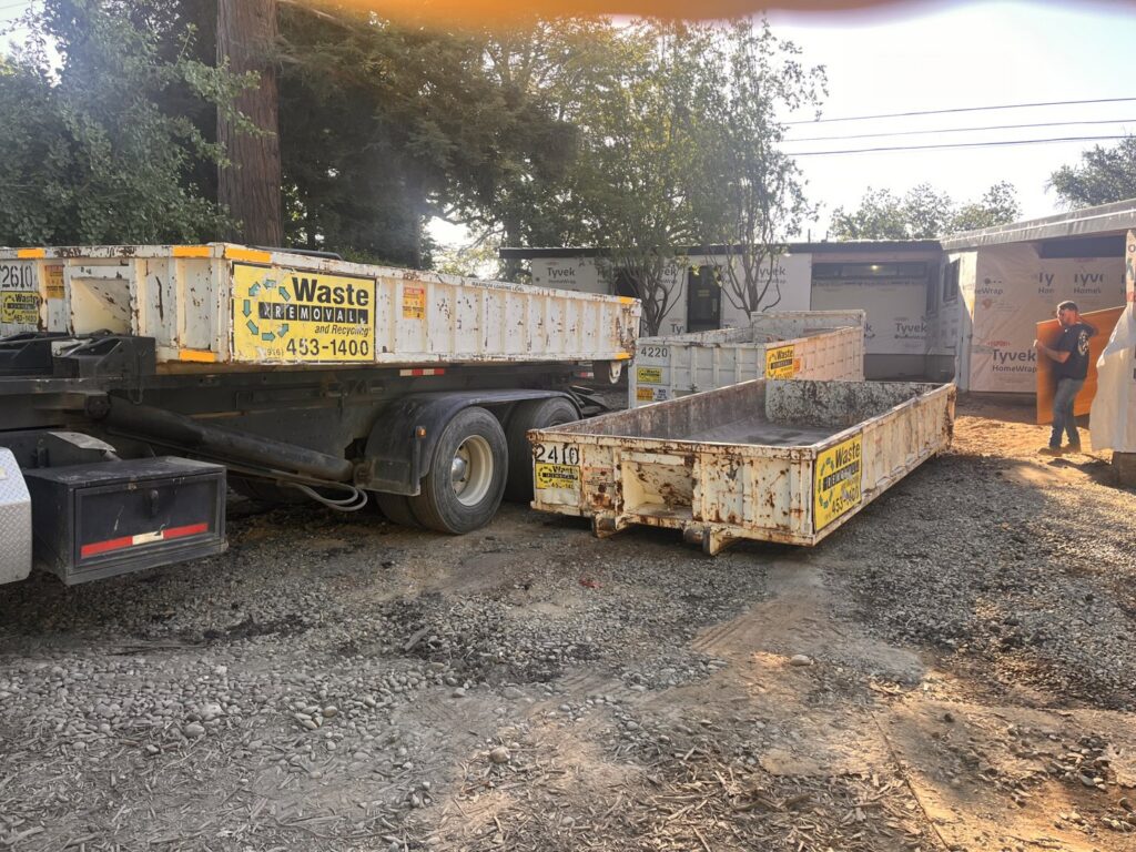A Waste Removal and Recycling, Inc. truck and dumpsters on a construction site in Sacramento, CA, for general junk removal.