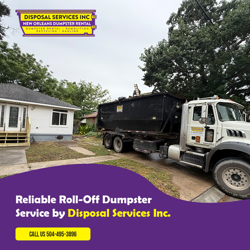 A roll-off dumpster on a truck parked in front of a residential house by Disposal Services Inc. in New Orleans, LA