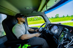 A green dumpster containing yard waste and debris, illustrating general junk removal services by Pack Mule Dumpsters Dayton, OH.
