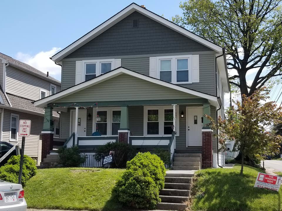 Exterior view of a duplex with newly installed windows and siding by The Window Man of Ohio in Westerville, OH.