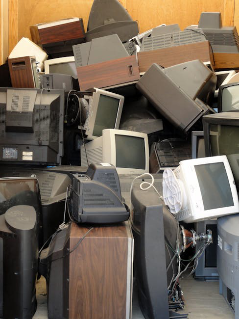 A large pile of old CRT monitors and televisions collected by E-Waste Recovery Systems in Sacramento, CA.