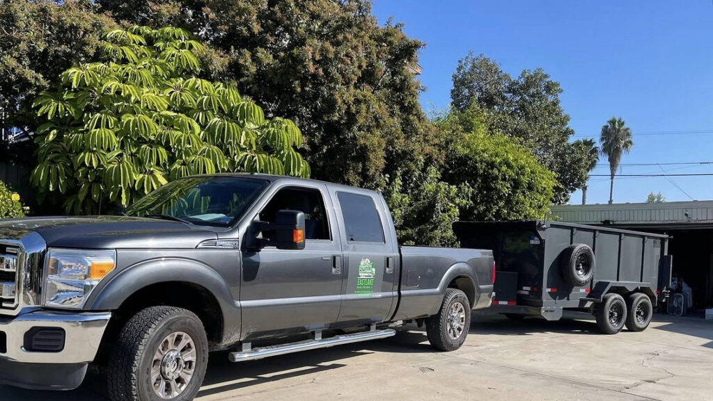 An Eastlake Hauling and Junk Removal, LLC truck with a dump trailer ready for a job in Chula Vista, CA.