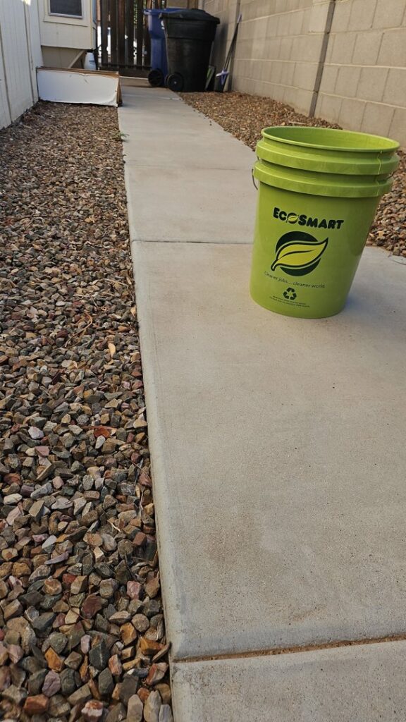 A green EcoSmart bucket used for pet waste collection services by EcoScoops Pet Waste Removal in Gilbert, AZ.
