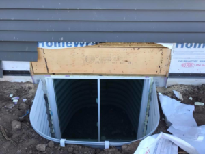 Egress window installation in progress on a home by Al Dorn Construction in De Pere, WI.