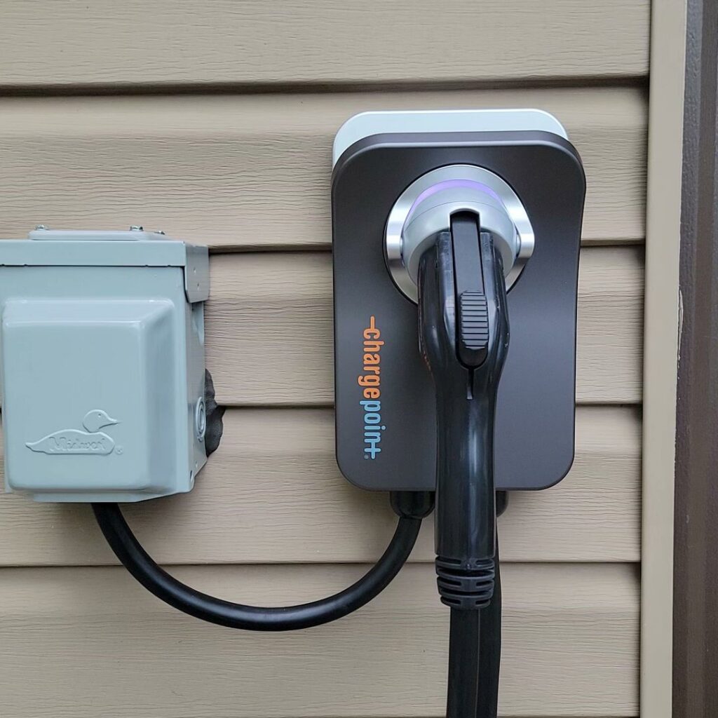 An electric vehicle charging station installed on the exterior of a home by MorLite Electric in Newport News, VA.