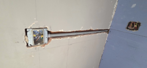 Electrical box and conduit installation in a wall with drywall work by AJ's Drywall & Finishing, LLC in St. Louis, MO.