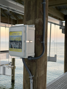 An electrical control box for a boat lift installed on a pier post by Payne's Marine Service, LLC in Fairhope, AL