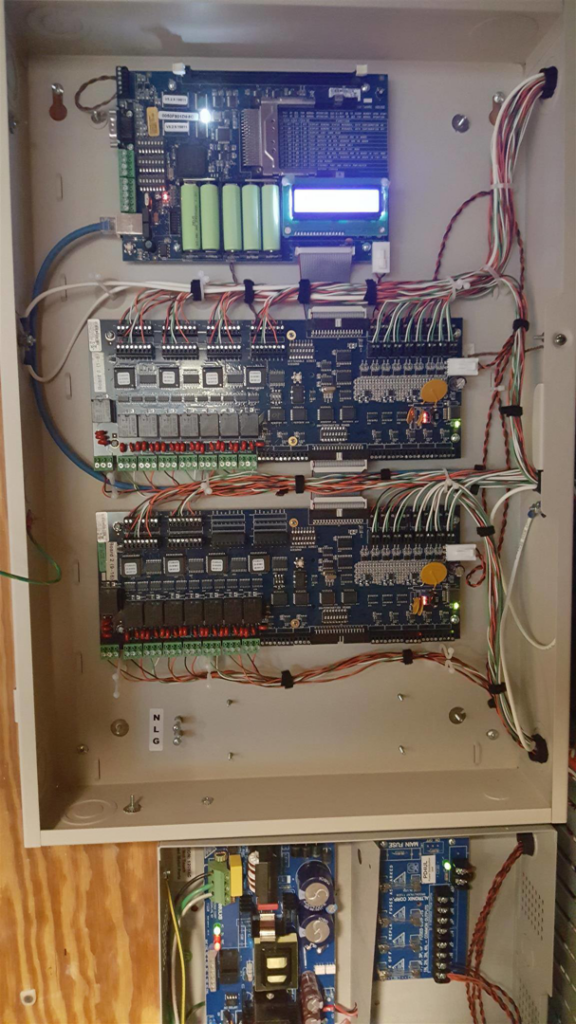 An open electrical control panel with circuit boards and wiring, showing an installation or repair by Premise Solutions in Cleveland, OH.