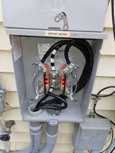 An open electrical box showing an export meter installation by Paramount Development in Milwaukee, WI.