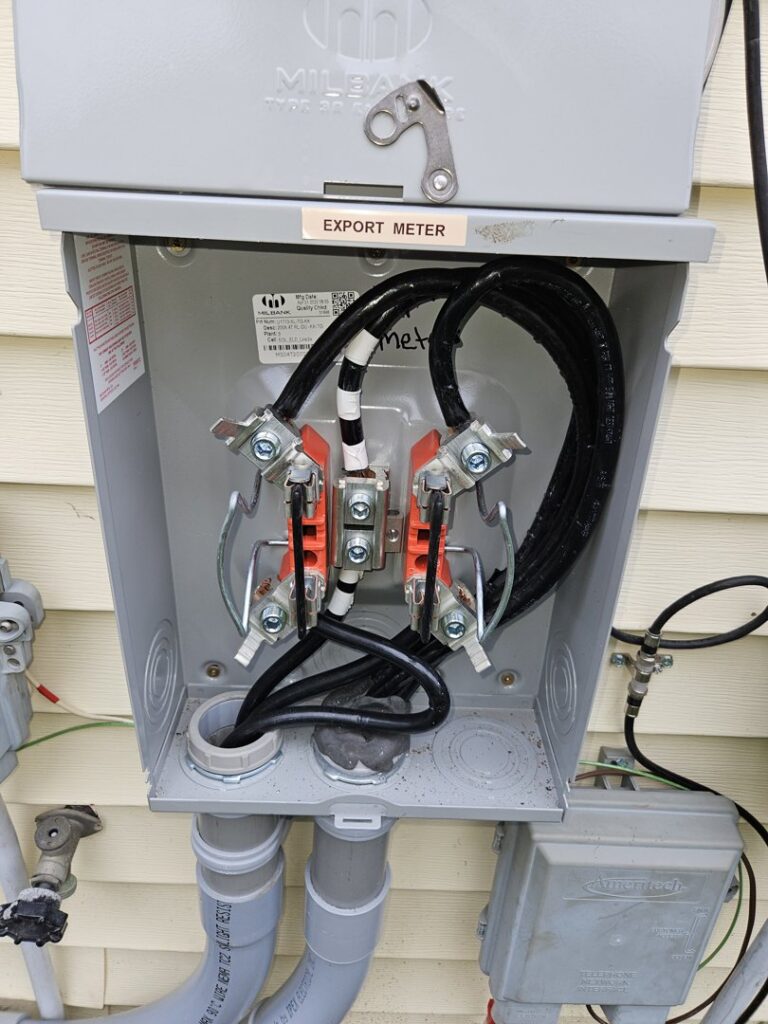 An open electrical box showing an export meter installation by Paramount Development in Milwaukee, WI.