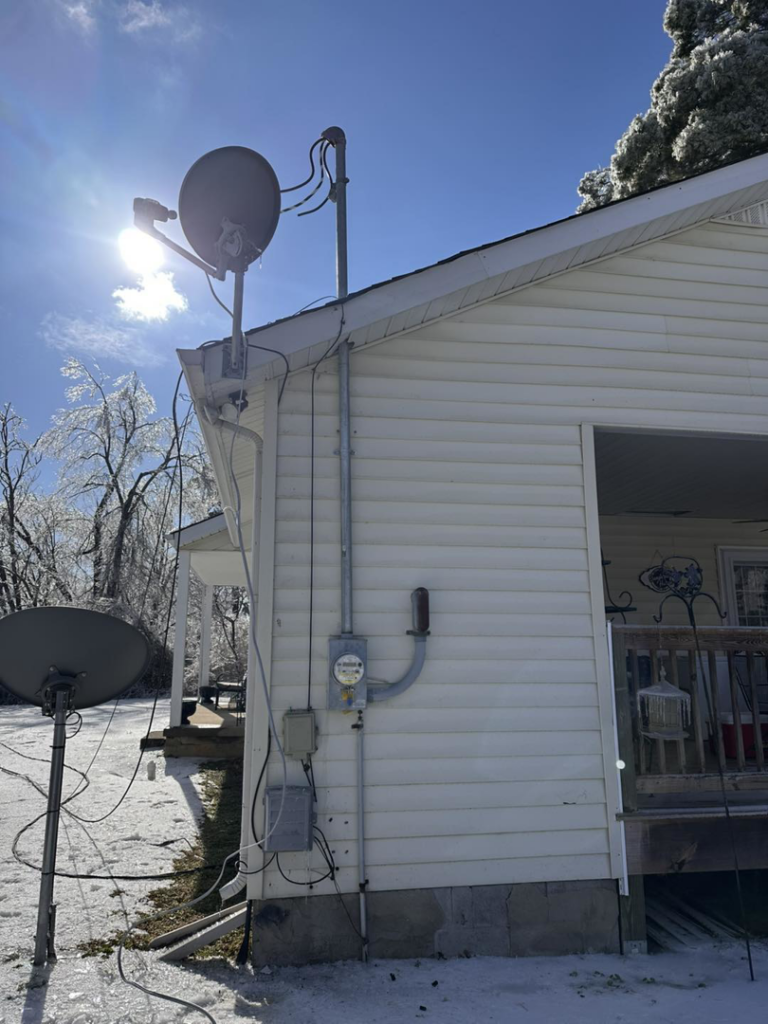 Exterior electrical meter and satellite dish installation on a house by HHS Contractors in Providence Village, TX.