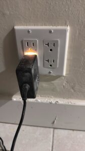 An electrical outlet being tested with a plug-in tester by Priority One Home Repair LLC in Glendale, AZ