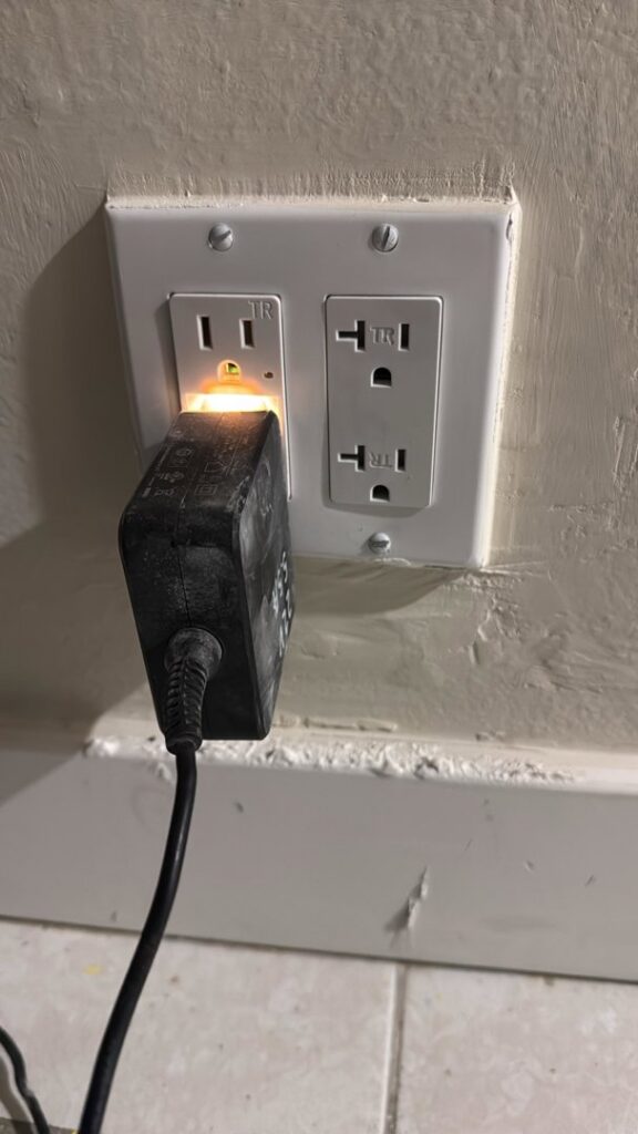 An electrical outlet being tested with a plug-in tester by Priority One Home Repair LLC in Glendale, AZ