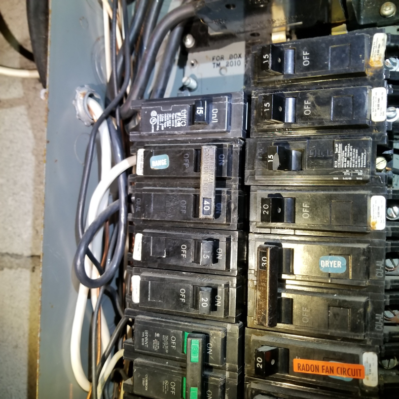 A close-up view of an electrical panel with circuit breakers, a service offered by Paul's Handyman Solutions in Lexington, KY.