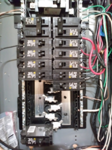 A close-up view of an electrical panel with circuit breakers and wiring, showing electrical work by Doug's Handyman Service in Sioux Falls, SD.