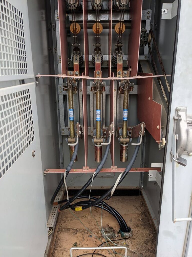 An open electrical panel showing fuses and wiring, demonstrating infrastructure work by RamTelecomLLC in Houston, TX