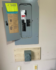 An electrical service panel and outdoor outlet installation inside a home by Gingy's Electrical Services, LLC in Memphis, TN.